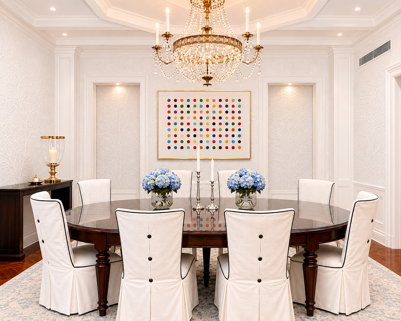 Formal dining room with crystal chandelier and Damien Hirst spot painting