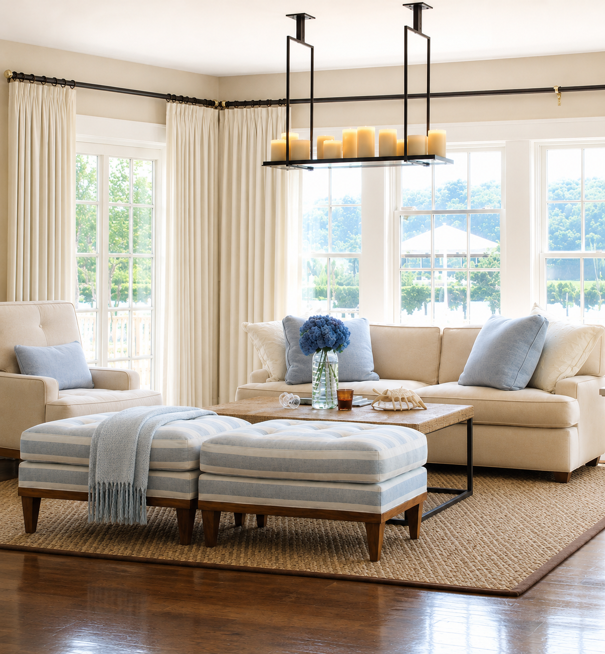 Hamptons living room with blue-striped ottomans and candle chandelier